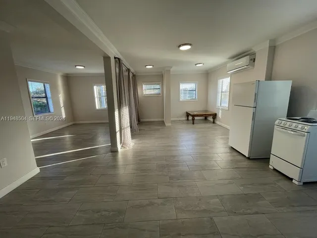 a view of a refrigerator in kitchen and a sink