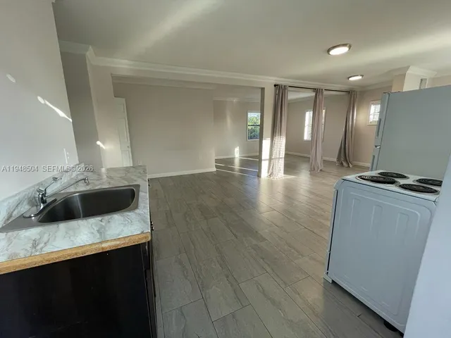 a kitchen with a sink and a refrigerator