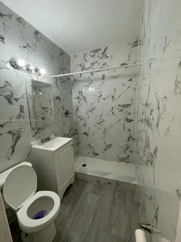 a bathroom with a toilet and a shower