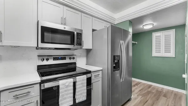 a kitchen with a refrigerator stove and microwave