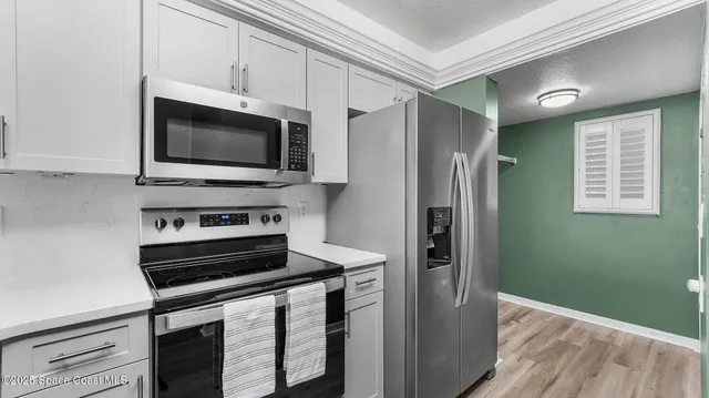 a kitchen with a refrigerator stove and microwave