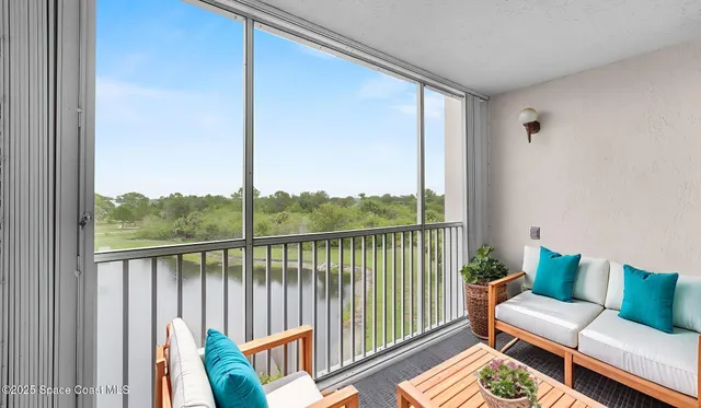a balcony with furniture and a potted plant
