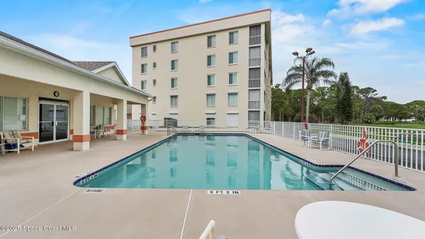a view of a swimming pool with a patio