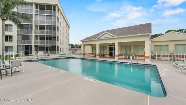 a view of a swimming pool with outdoor seating