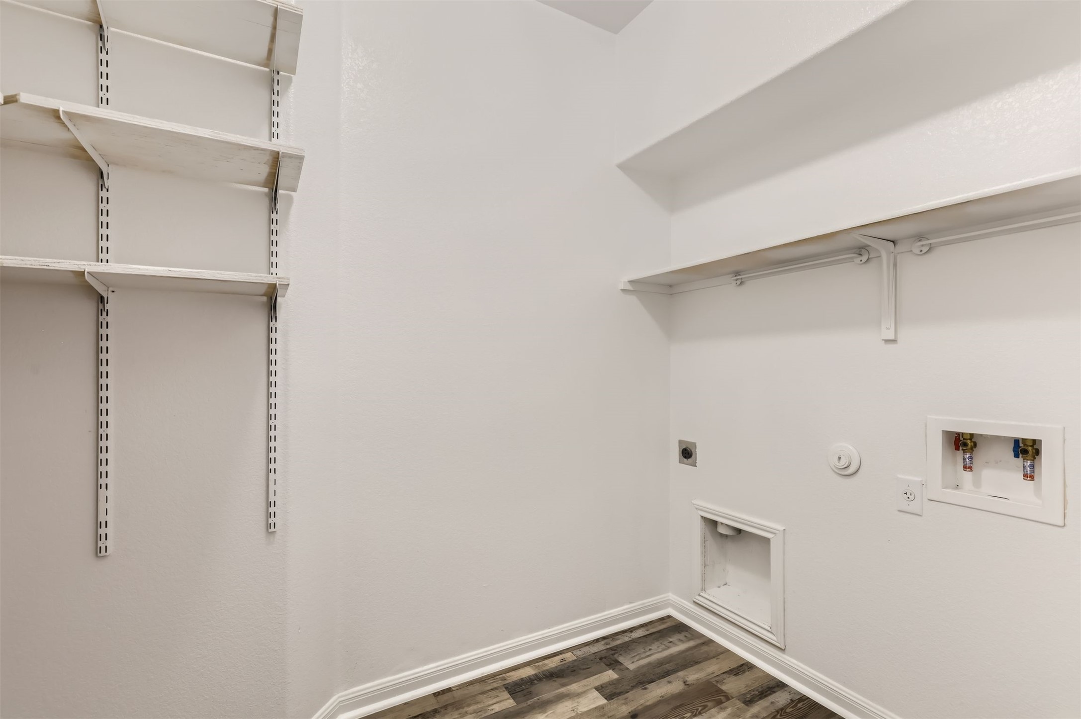 131 Lavaca Loop Hutto, TX 78634 - Photo 13 of 29 Functional laundry room offers convenient shelving and utility hookups for effortless chores.
