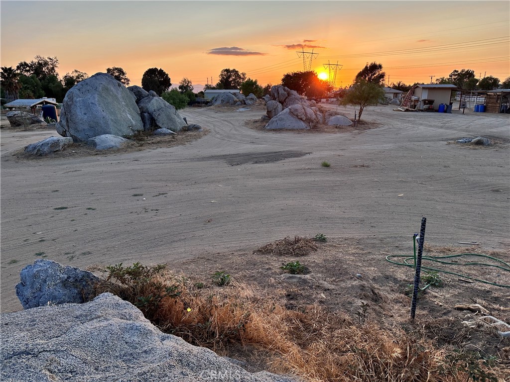 29163 Patelli Way Menifee, CA 92585 - Photo 8 of 23 a view of a dry yard with a barn