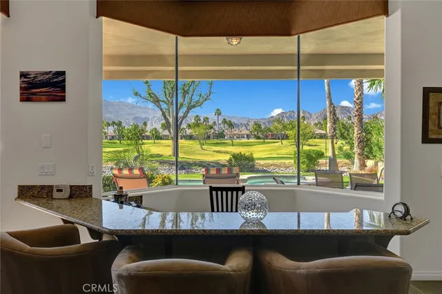 a dining room with furniture and window