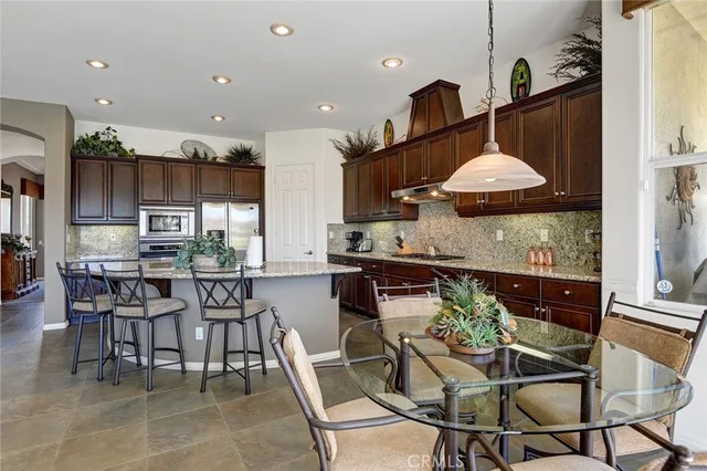 a kitchen with a table and chairs in it