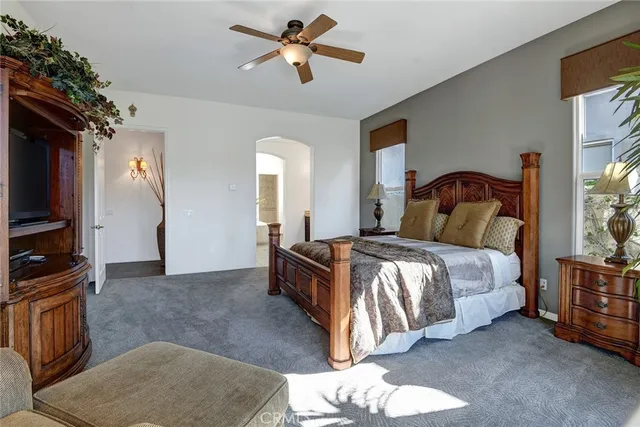 a bedroom with a bed and a chandelier