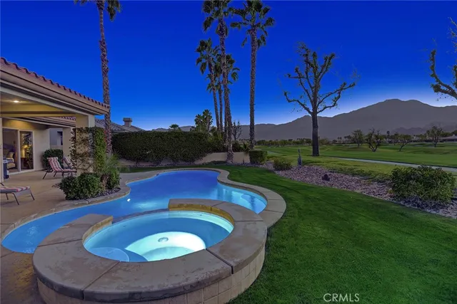 a view of a swimming pool with a yard