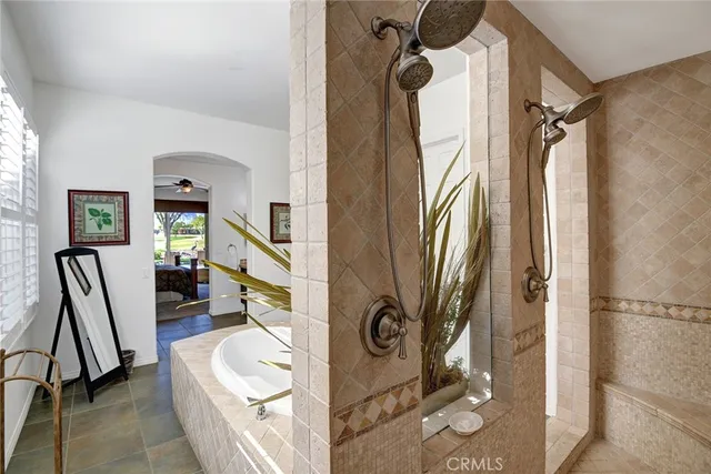 a bathroom with a sink a mirror a bathtub and a shower