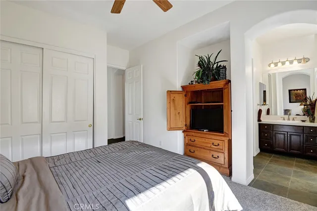 a bedroom with a bed and a television in it