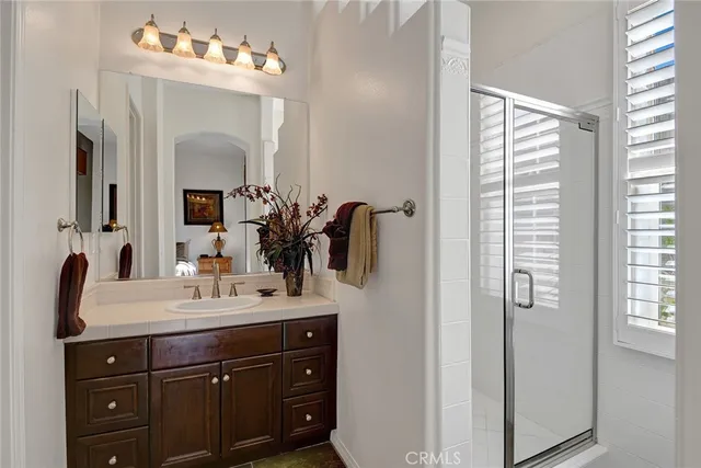 a bathroom with a sink vanity and mirror