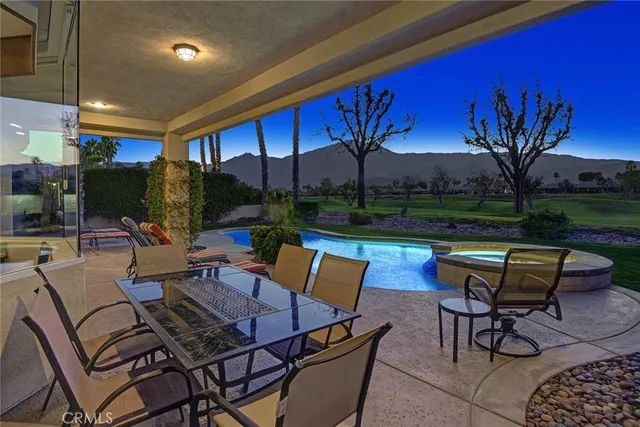 a backyard of a house with outdoor seating