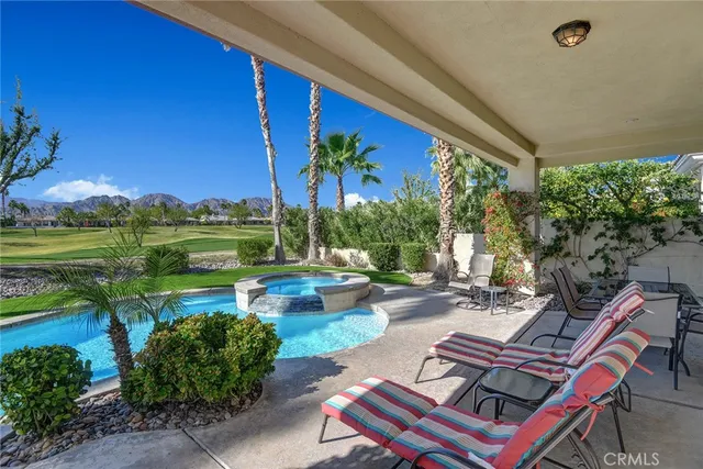 a backyard of a house with outdoor seating