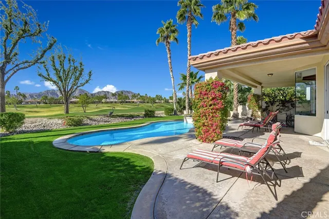 a view of a patio with a table and chairs