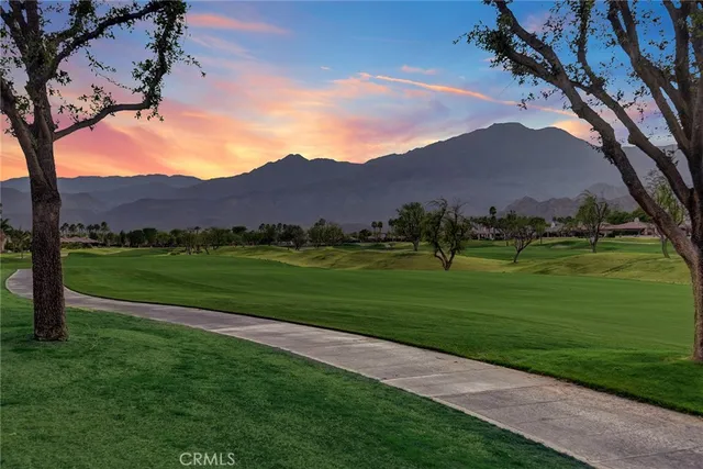a view of grassy field with mountain
