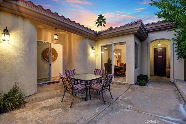 a view of a dinning room with a table and chairs