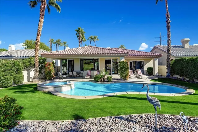 a view of a house with a yard porch and sitting area