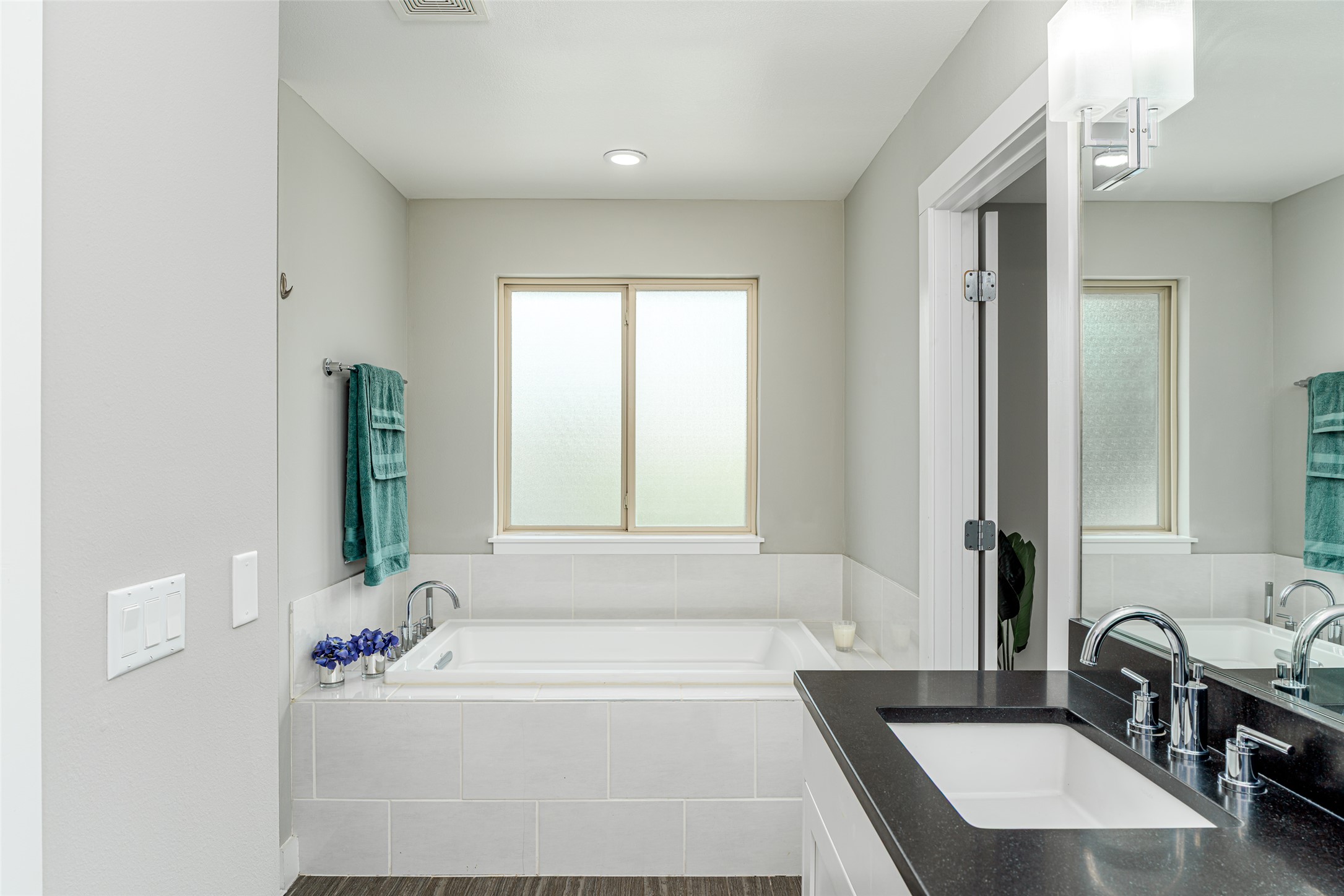 705 East 49th Street, Unit A Austin, TX 78751 - Photo 21 of 40 a bathroom with a tub sink and mirror