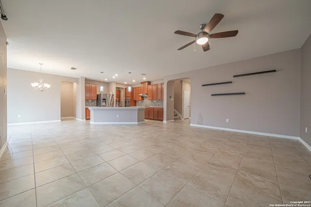 a view of a livingroom with a ceiling fan and window