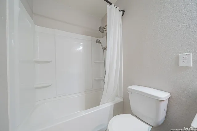 a bathroom with a double vanity sink toilet mirror and bathtub