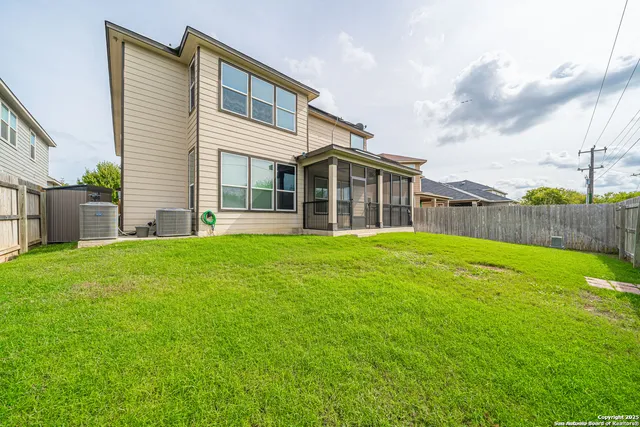 a view of a house with a yard and sitting area