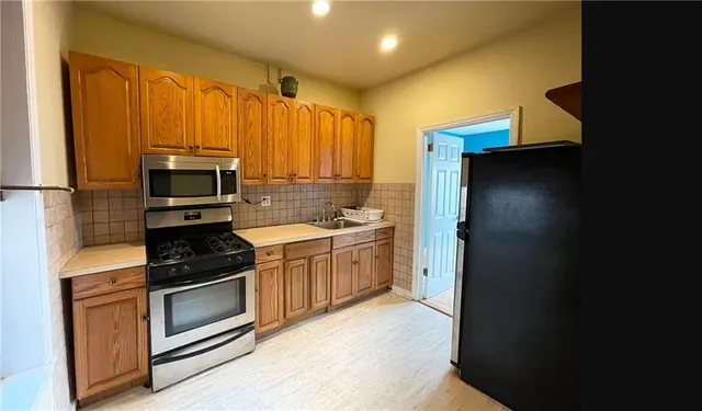 a kitchen with a sink stove and microwave
