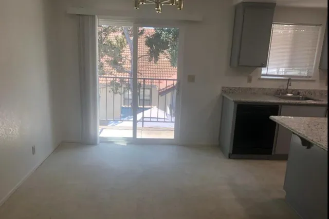 a kitchen with granite countertop a sink and a stove