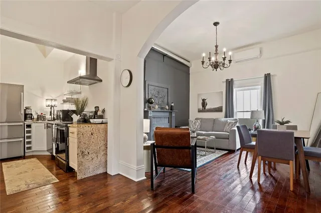 a bedroom with a bed a mirror and a window