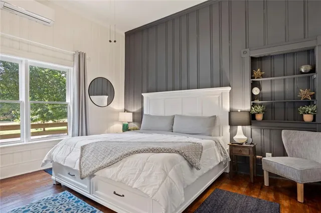 a bedroom with a bed and a flat screen tv