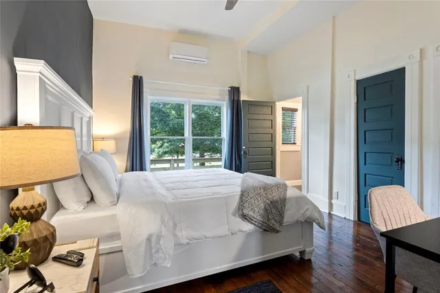 a bedroom with a bed and a large window