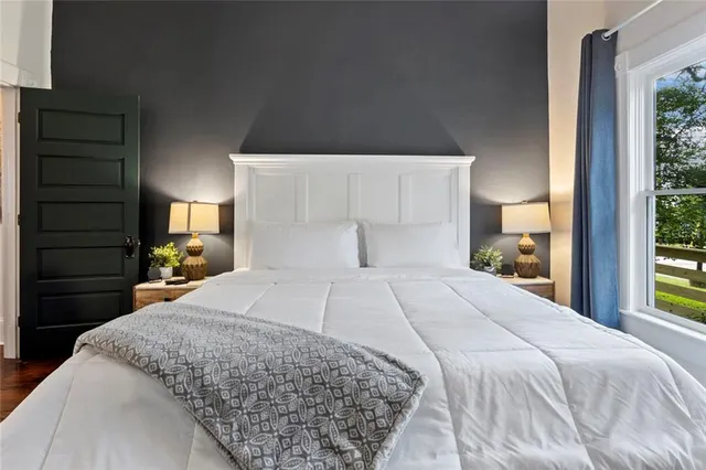 a view of a hallway with wooden floor and closet