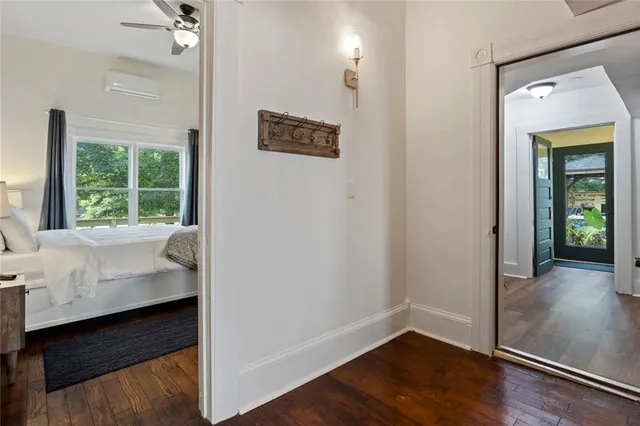 a living room with furniture wooden floor and a large window