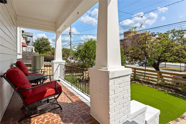 a view of house with backyard and sitting area