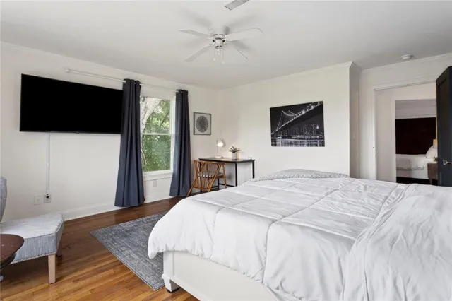 a living room with furniture a large window and a refrigerator