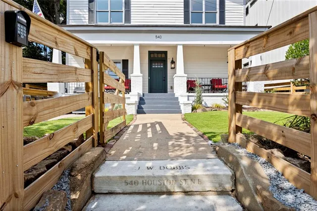 a view of a yard with wooden fence