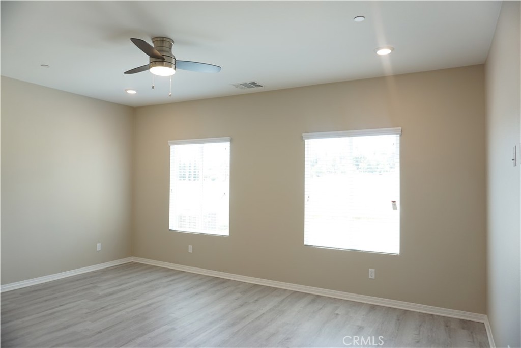 128 Chumash Perris, CA 92570 - Photo 13 of 22 wooden floor in an empty room with a window