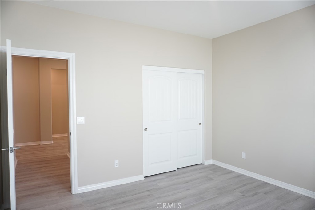128 Chumash Perris, CA 92570 - Photo 14 of 22 an empty room with wooden floor & closet area