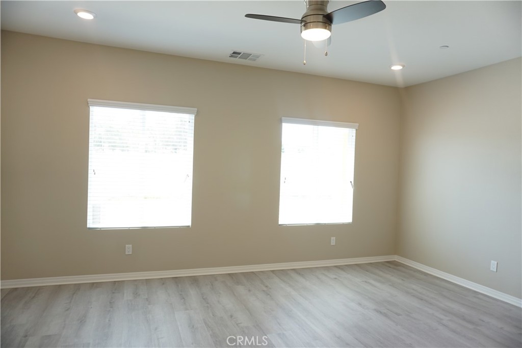 128 Chumash Perris, CA 92570 - Photo 15 of 22 an empty room with a window and a ceiling fan