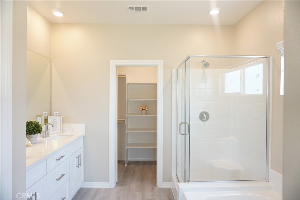 128 Chumash Perris, CA 92570 - Photo 16 of 22 a bathroom with a shower sink and mirror