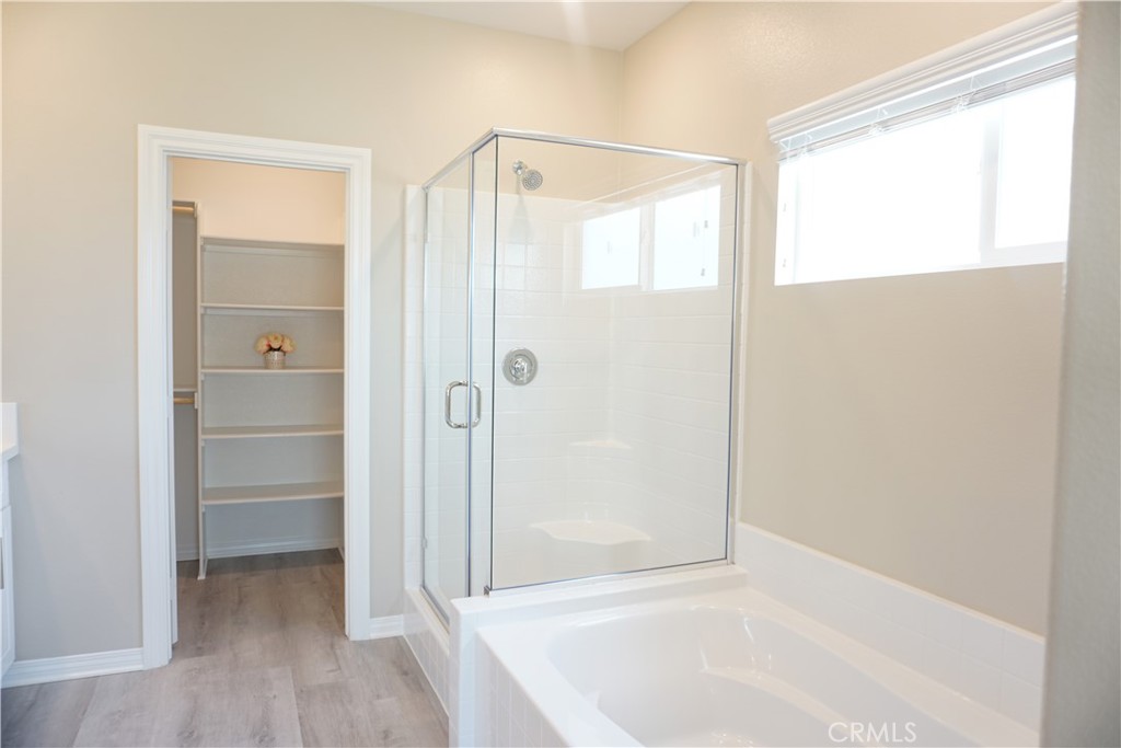 128 Chumash Perris, CA 92570 - Photo 17 of 22 a bathroom with a bathtub and a shower