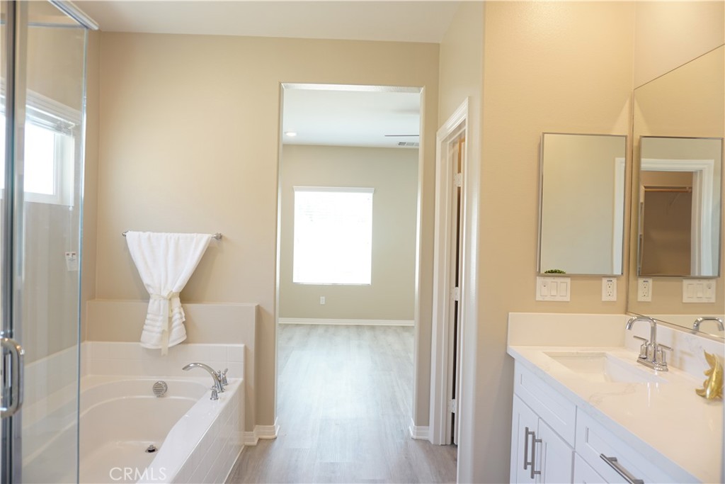 128 Chumash Perris, CA 92570 - Photo 18 of 22 a bathroom with a bathtub sink and mirror