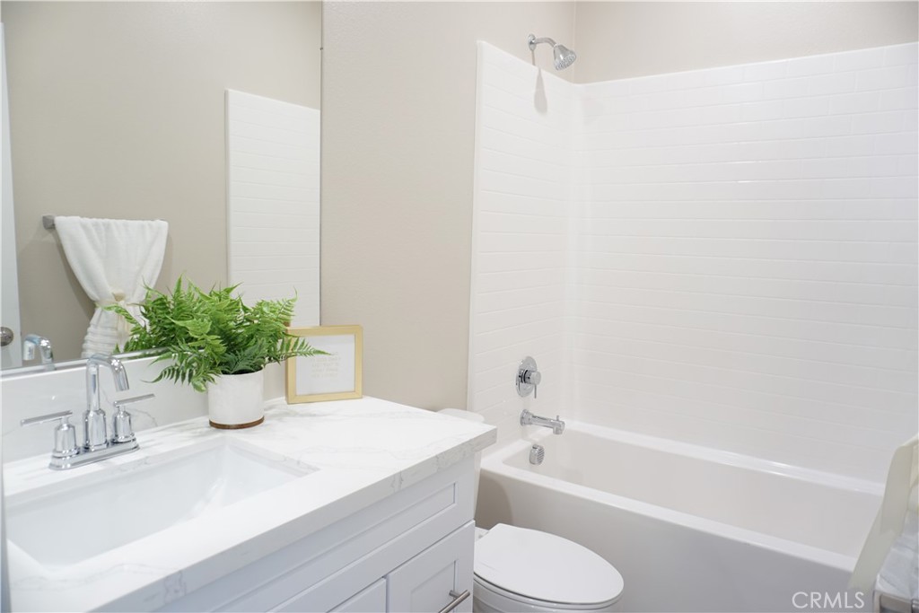 128 Chumash Perris, CA 92570 - Photo 19 of 22 a bathroom with a sink toilet and shower
