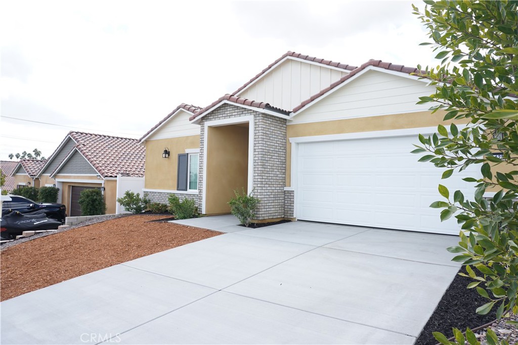 128 Chumash Perris, CA 92570 - Photo 3 of 22 a view of a white house next to a road and yard