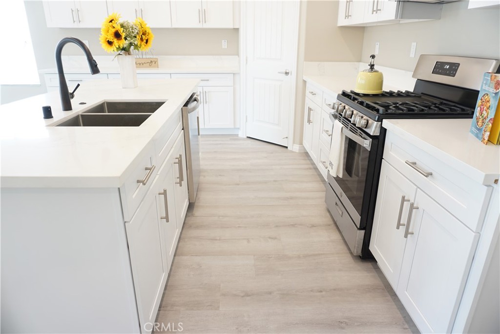 128 Chumash Perris, CA 92570 - Photo 8 of 22 a kitchen with sink stove and refrigerator