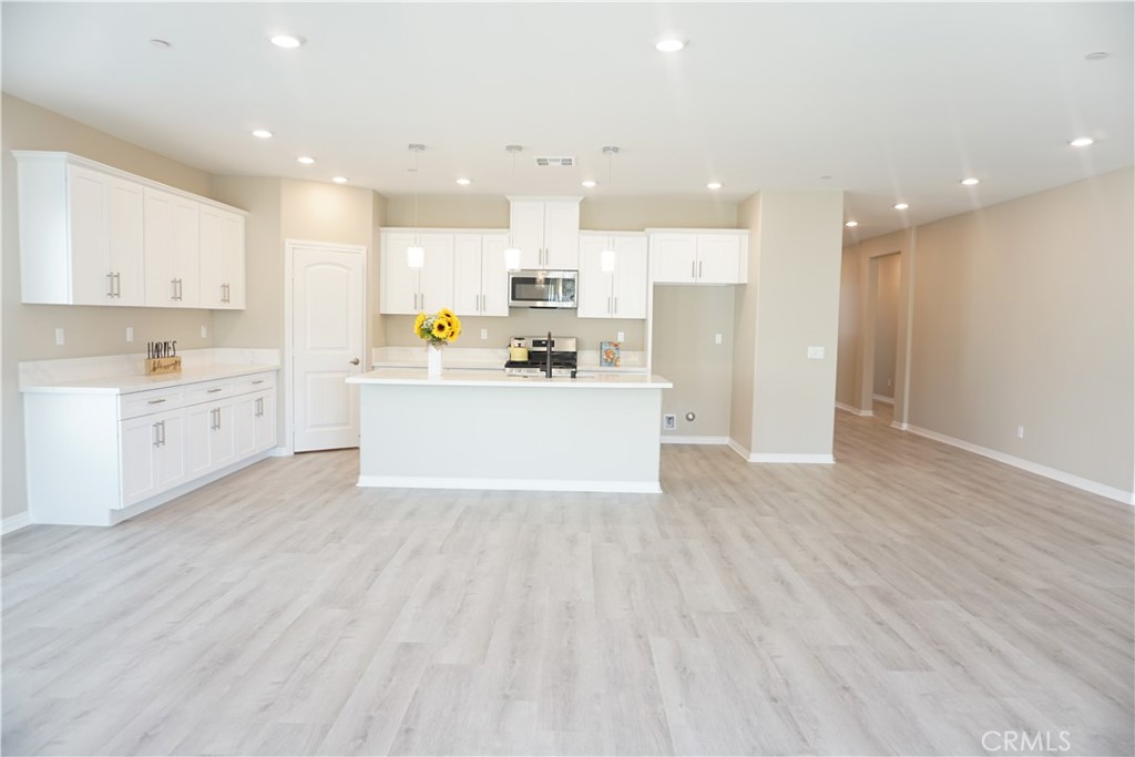 128 Chumash Perris, CA 92570 - Photo 9 of 22 a view of kitchen with kitchen island a sink stainless steel appliances and cabinets