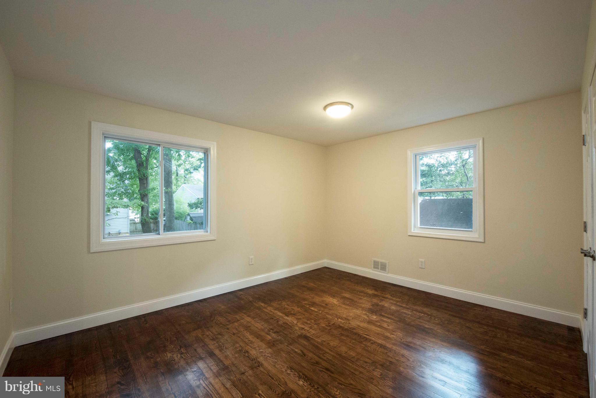 1808 Glenarm Road Edgewater, MD 21037 - Photo 11 of 29 a view of an empty room with wooden floor and a window