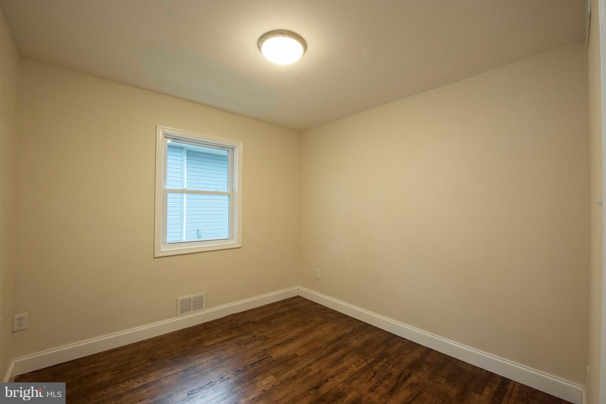 1808 Glenarm Road Edgewater, MD 21037 - Photo 14 of 29 an empty room with wooden floor and windows