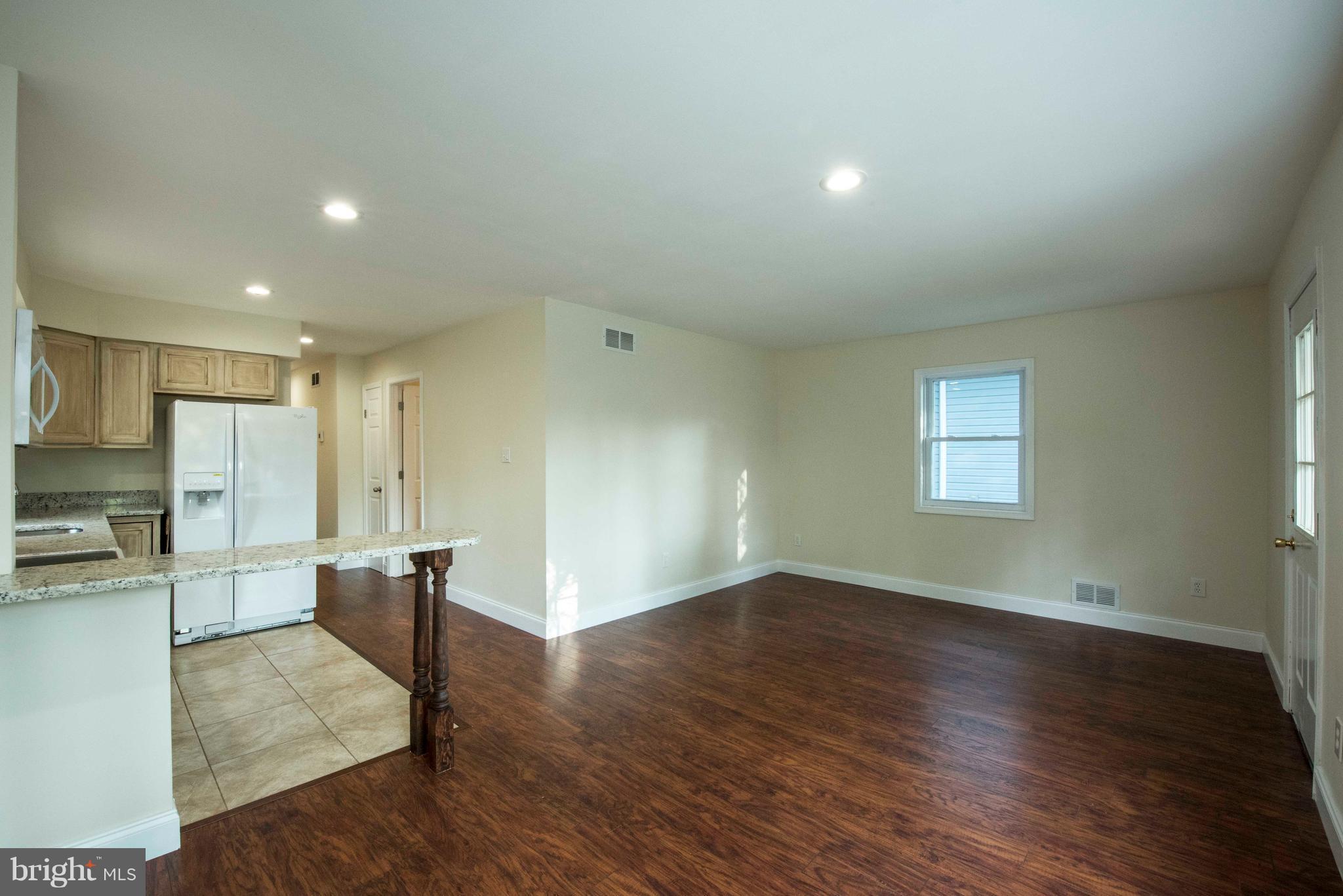 1808 Glenarm Road Edgewater, MD 21037 - Photo 5 of 29 an empty room with wooden floor and windows